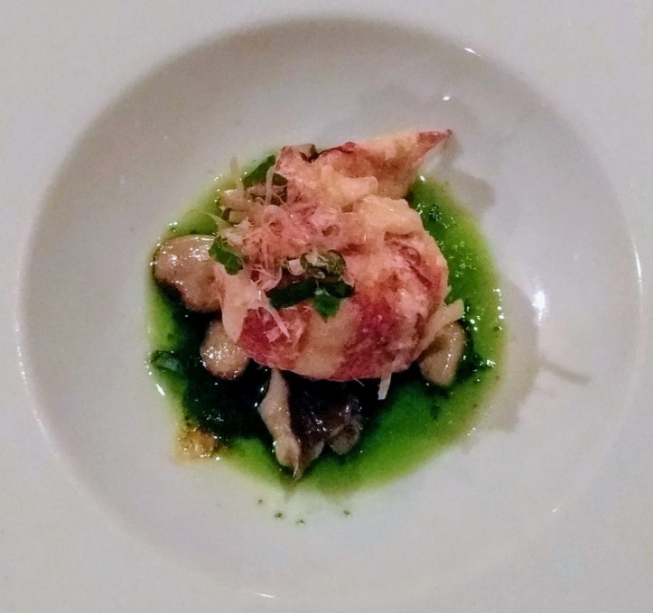 Kona cold lobster on a plate of hamakua eryngii mushrooms and green oil.