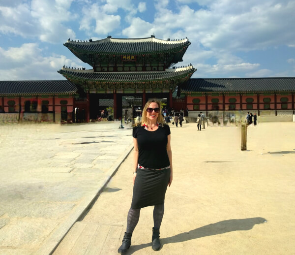 A woman poses in front of Heungnyemun the second Gate of Gyeongbokgung in Seoul, South Korea.